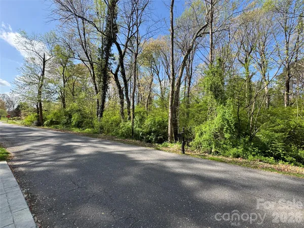 a view of a road with a building in the background