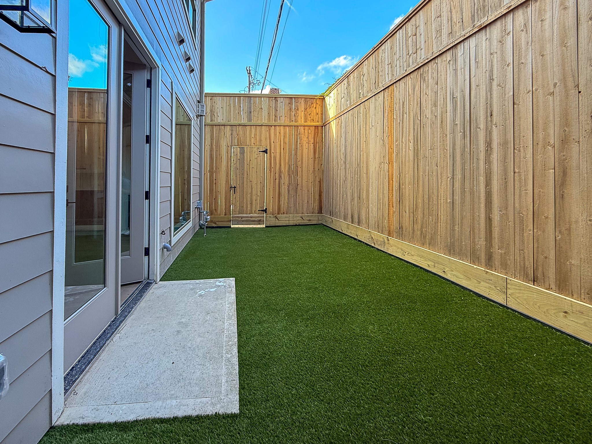 5329 Dora Street Houston, TX 77005 - Photo 38 of 43 Designed for effortless living, this lock-and-leave home features turf and a low-maintenance backyard space.