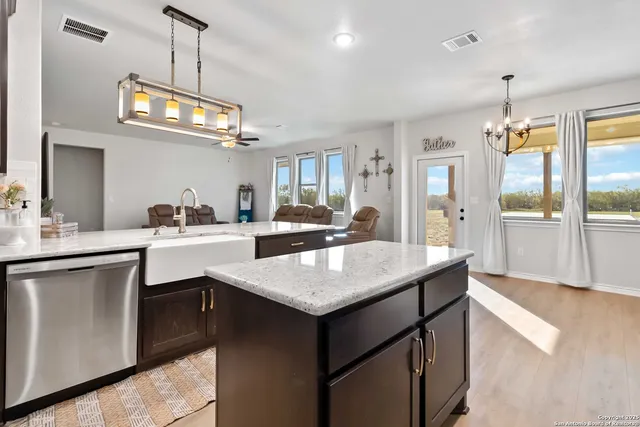 a kitchen with a counter space a sink appliances and cabinets