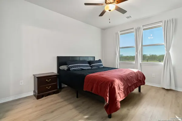 a bed sitting in a bedroom next to a window