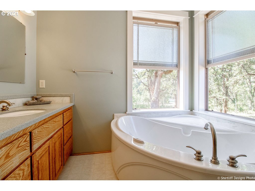 38636 Pengra Road Fall Creek, OR 97438 - Photo 14 of 32 a bathroom with a tub sink and mirror