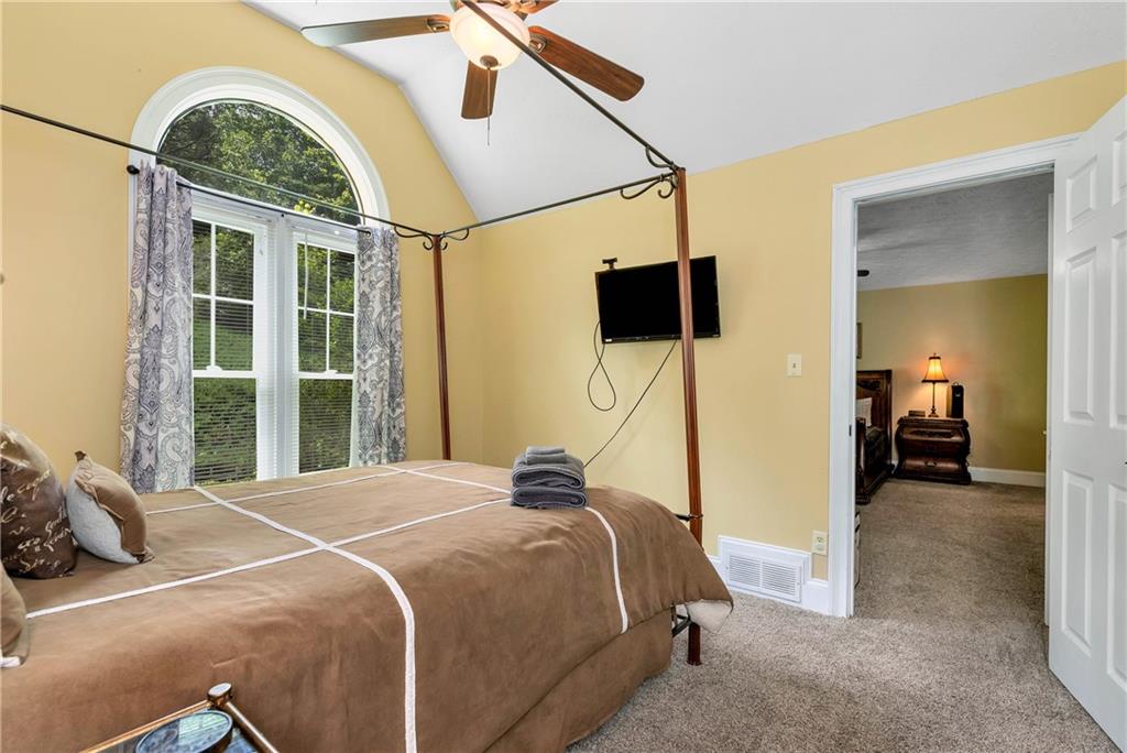 276 Zeppelin Strasse Helen, GA 30545 - Photo 19 of 60 a bedroom with a bed and a large window