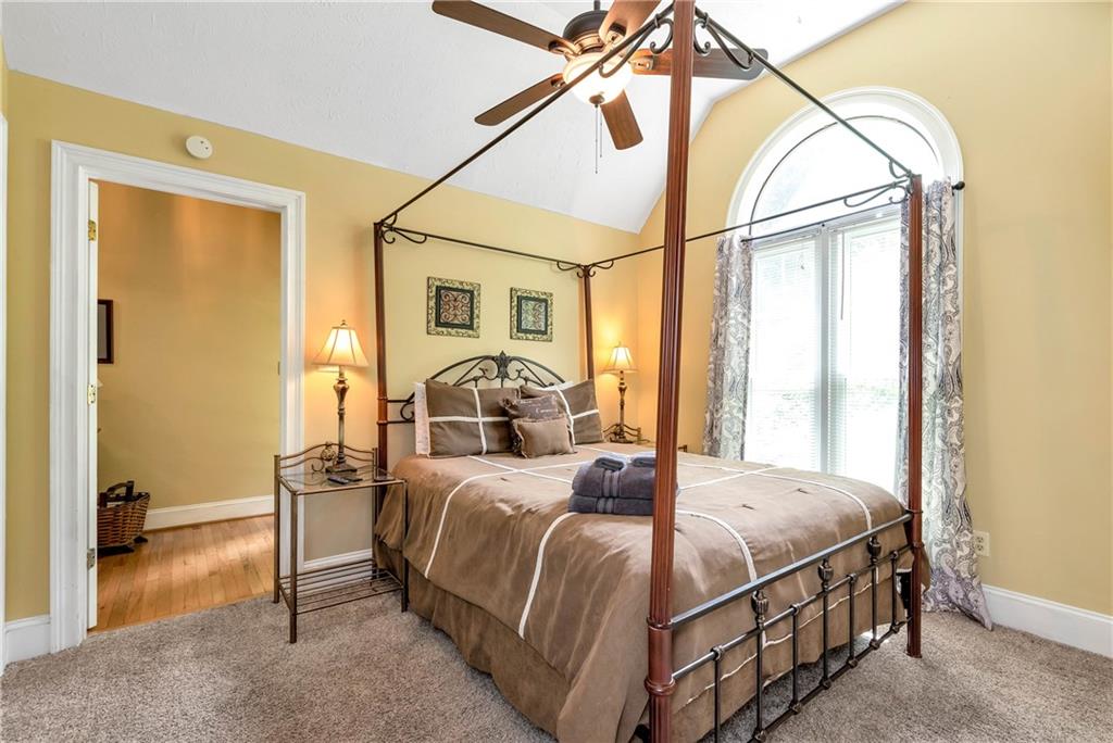 276 Zeppelin Strasse Helen, GA 30545 - Photo 21 of 60 a bedroom with a bed and a chandelier