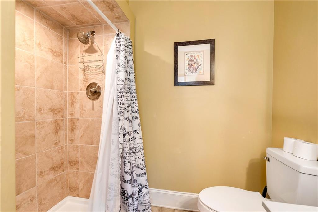 276 Zeppelin Strasse Helen, GA 30545 - Photo 27 of 60 a white toilet sitting next to a shower curtain