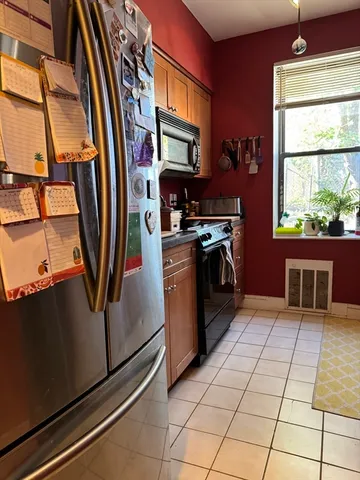 a kitchen with stainless steel appliances granite countertop a refrigerator and a stove