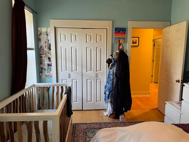 a view of hallway with wooden floor and windows
