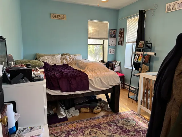 a bedroom with a bed and a window