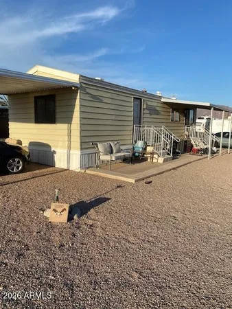 a backyard of a house with barbeque oven table and chairs