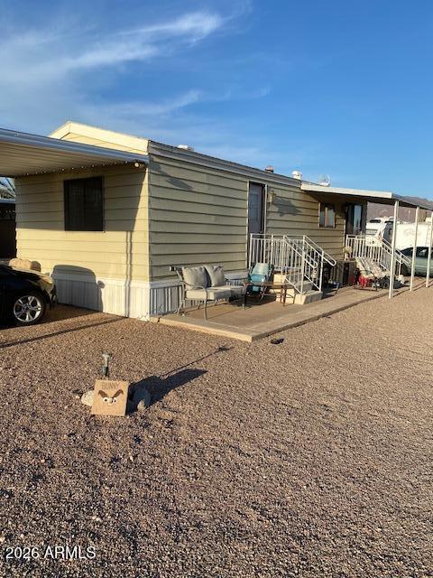 2015 South Wickiup Road, Unit 28 Apache Junction, AZ 85119 - Photo 2 of 5 a backyard of a house with barbeque oven table and chairs