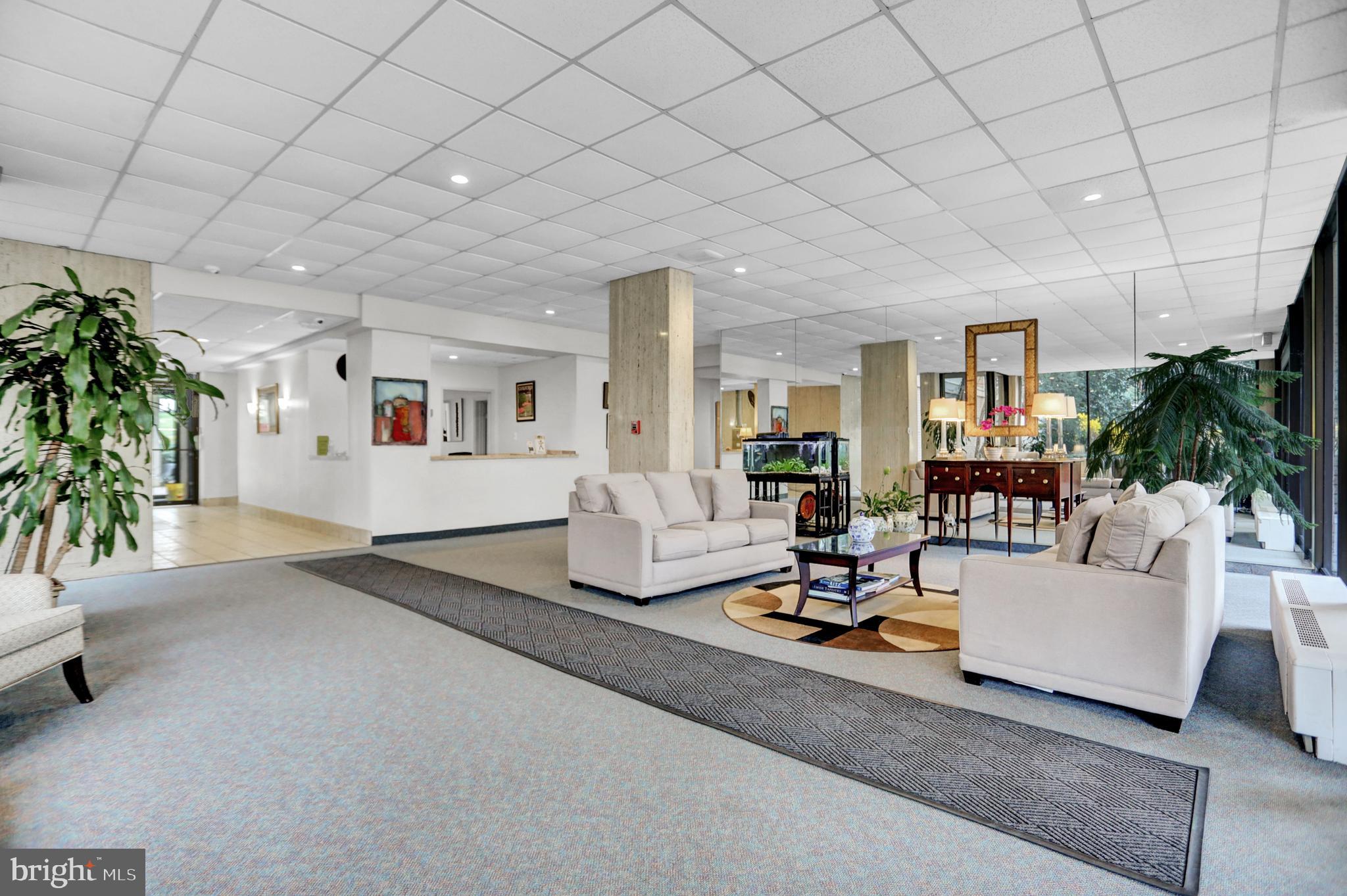 4401 Roland Avenue, Unit 304 Baltimore, MD 21210 - Photo 27 of 50 a living room with furniture and a table
