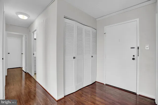 a view of an empty room with wooden floor