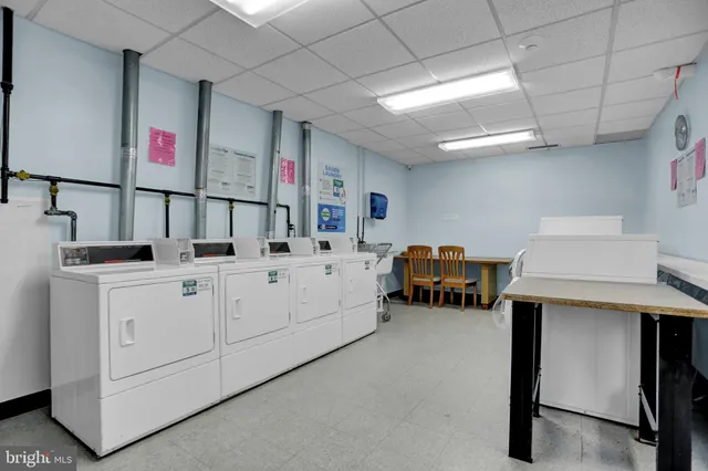 a utility room with multiple dryer and washer