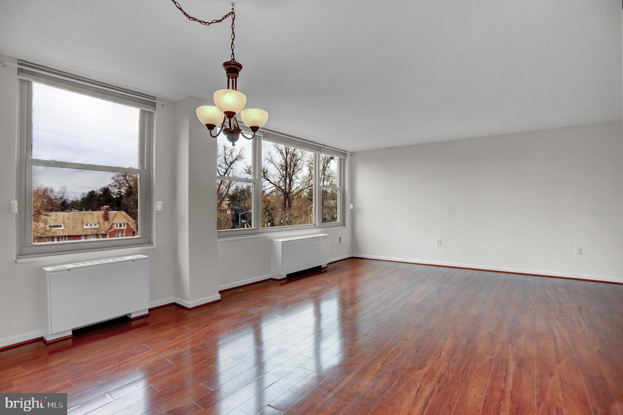 4401 Roland Avenue, Unit 304 Baltimore, MD 21210 - Photo 6 of 50 a view of an empty room with wooden floor and a window