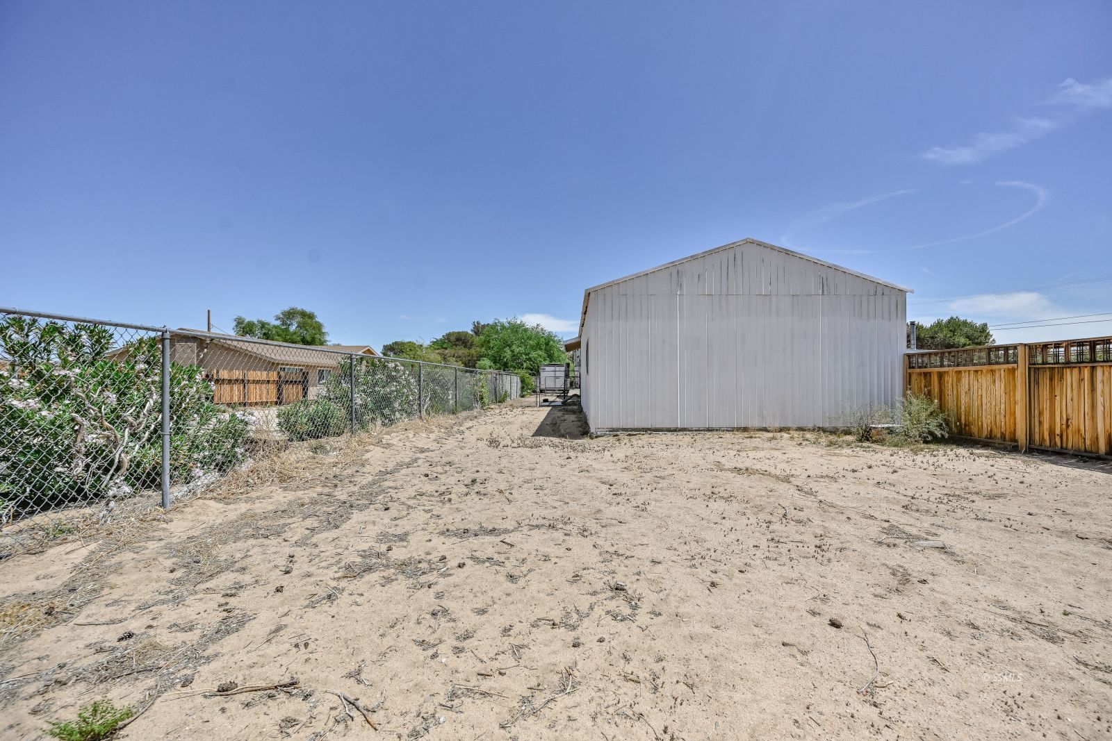 1407 North Indian Wells Street Ridgecrest, CA 93555 - Photo 49 of 50 a big house with a big yard and large tree