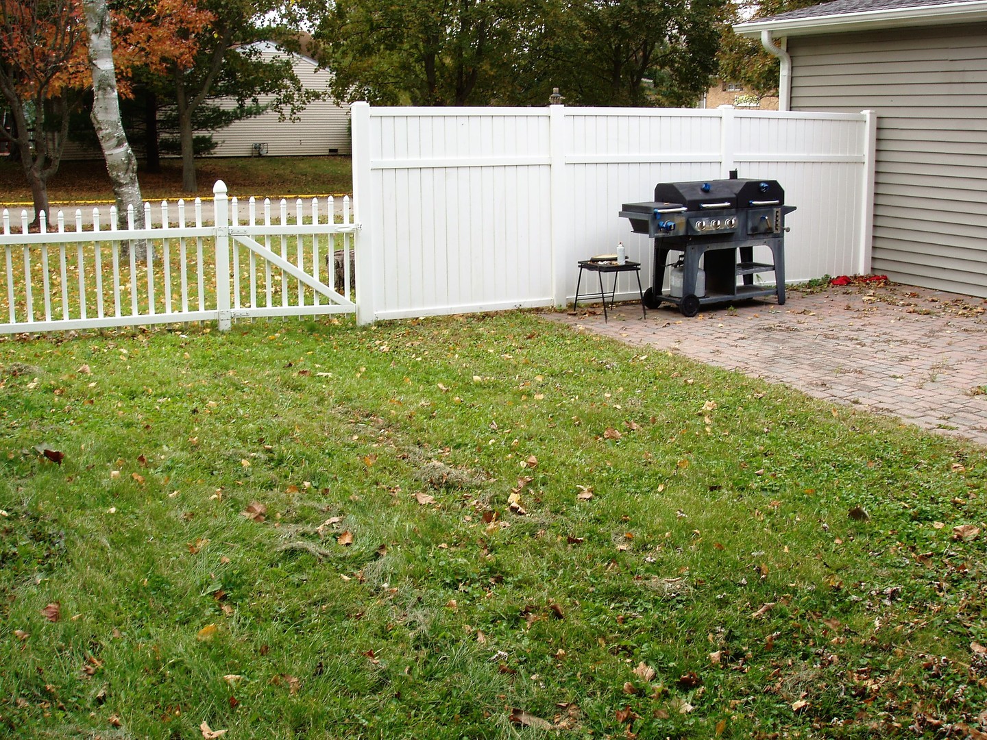 1102 Normal Road DeKalb, IL 60115 - Photo 21 of 22 a view of a bench in the backyard next to a white house