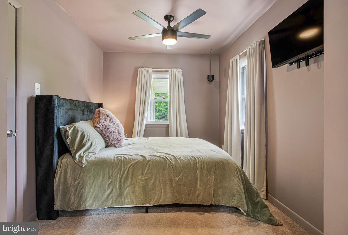 976 Shore Acres Road Arnold, MD 21012 - Photo 25 of 40 a bedroom with a bed and a flat screen tv