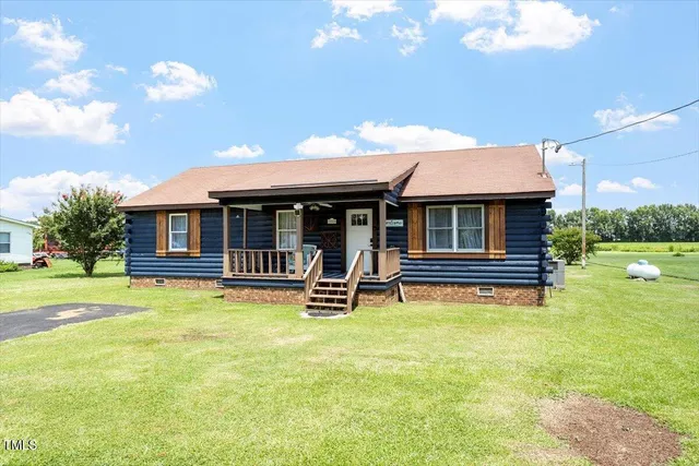 a backyard of a house with table and chairs