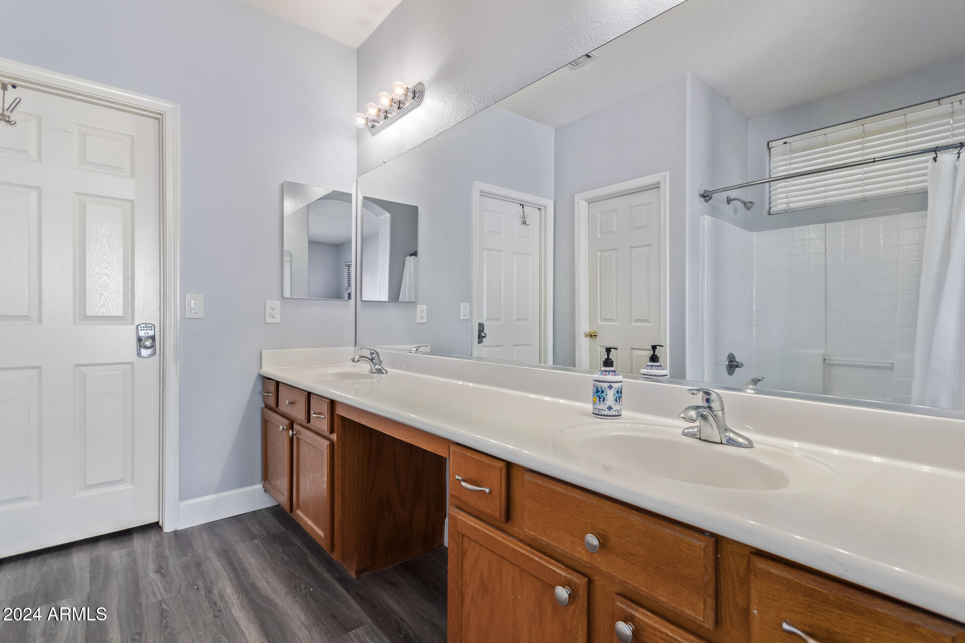 18750 East Ryan Road Queen Creek, AZ 85142 - Photo 20 of 36 a bathroom with a double vanity sink and a mirror