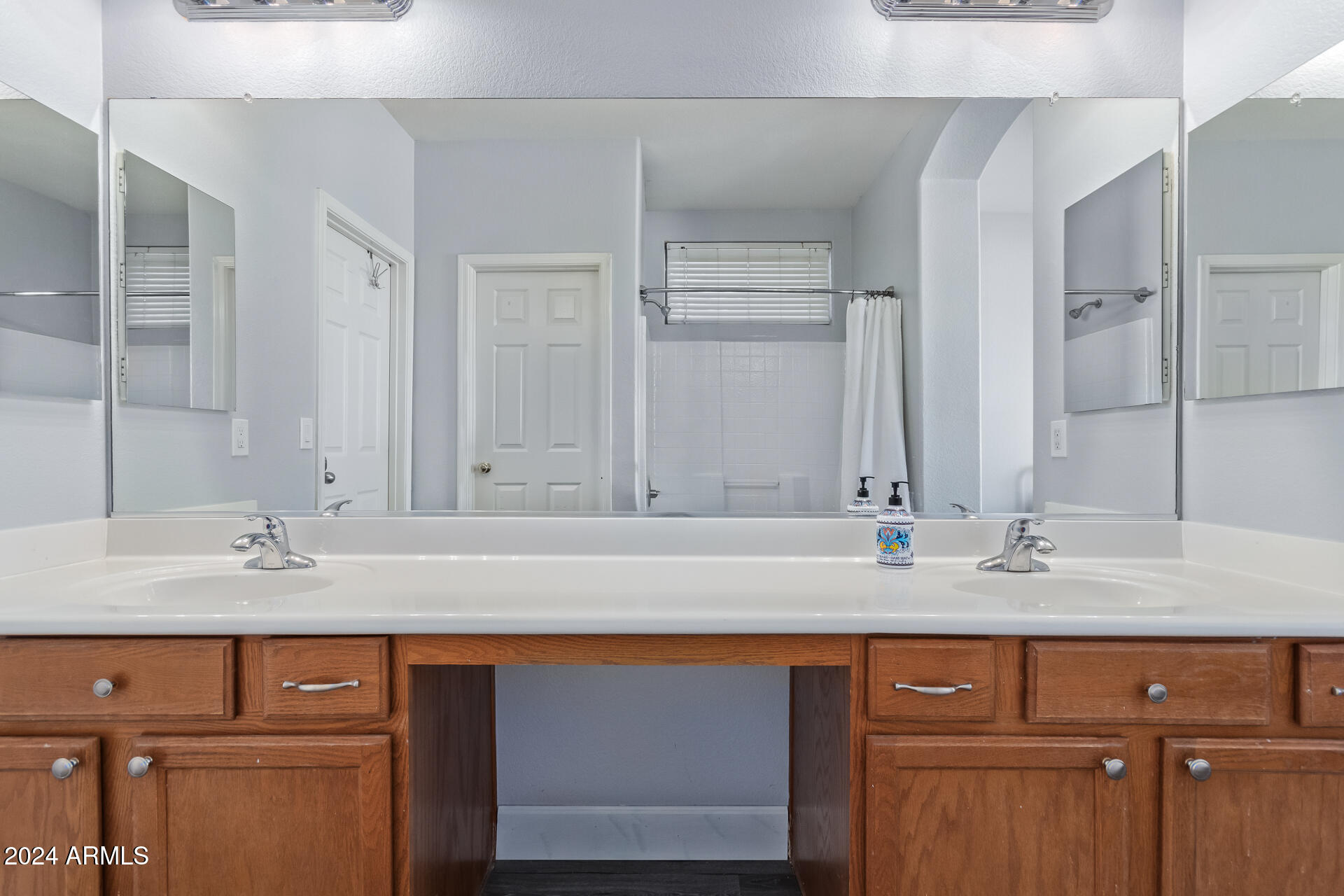 18750 East Ryan Road Queen Creek, AZ 85142 - Photo 21 of 36 a bathroom with a sink and a mirror