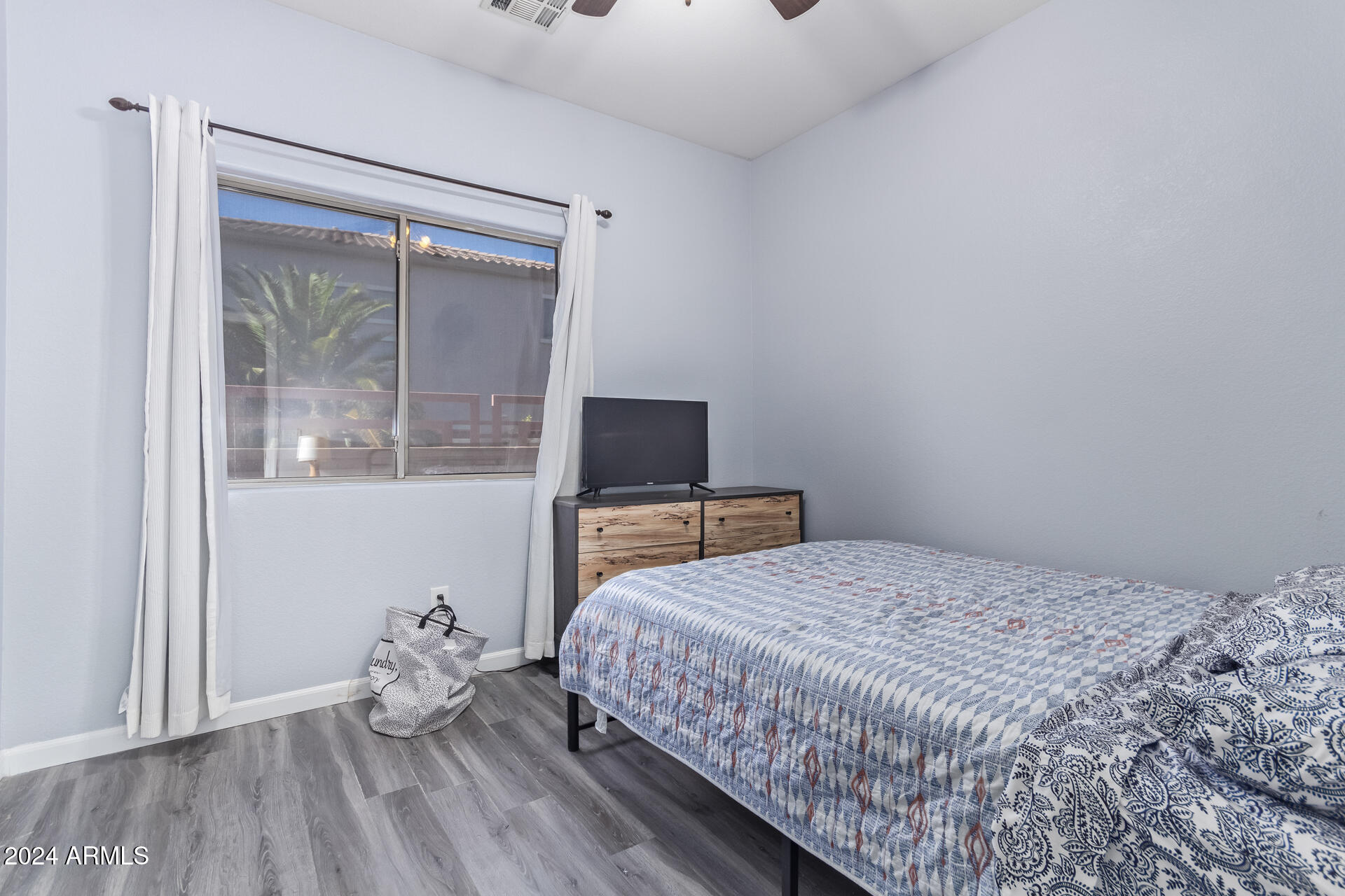18750 East Ryan Road Queen Creek, AZ 85142 - Photo 23 of 36 a bedroom with a bed and wooden floor