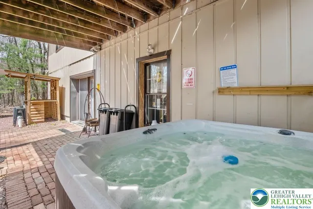a view of a livingroom with wooden floor and a refrigerator