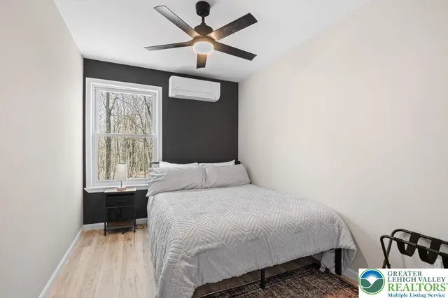 a bedroom with a bed and a window