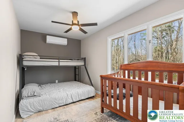 a bedroom with a bed and a large window