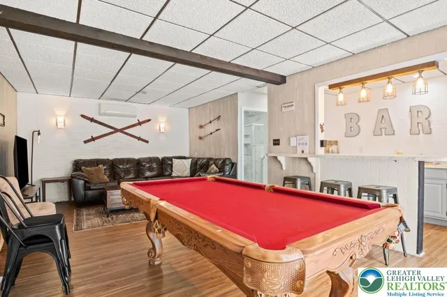 a room with pool table and windows