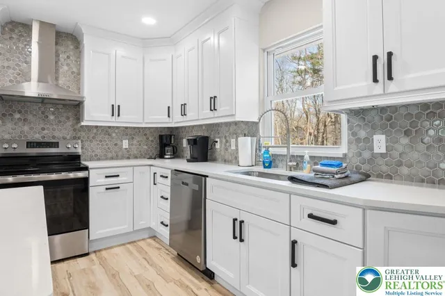 a kitchen with granite countertop white cabinets and white appliances