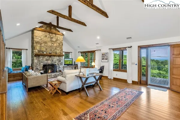 a living room with fireplace furniture and a wooden floor
