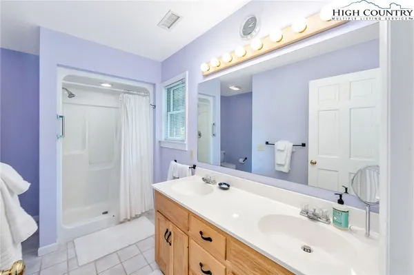 a spacious bathroom with a double vanity sink mirror and toilet