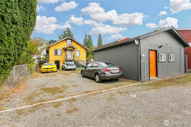 a car parked in front of a house with a parked car