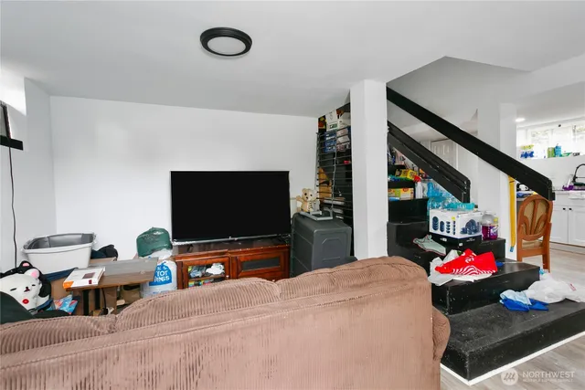 a bedroom with furniture and a flat screen tv