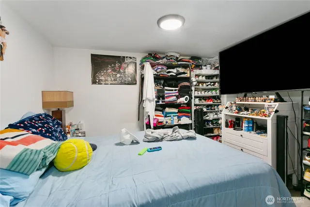 a bedroom with a bed and a flat screen tv
