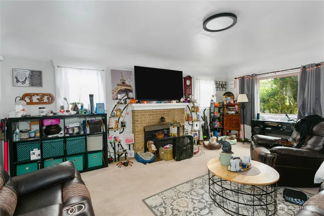 a room with furniture a flat screen tv and a window