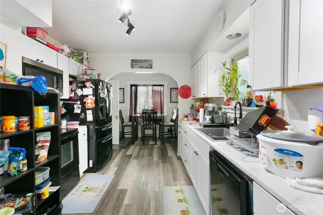 a kitchen that has a lot of cabinets a sink and a stove