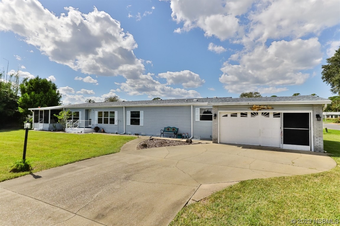 a front view of a house with a garden and trees