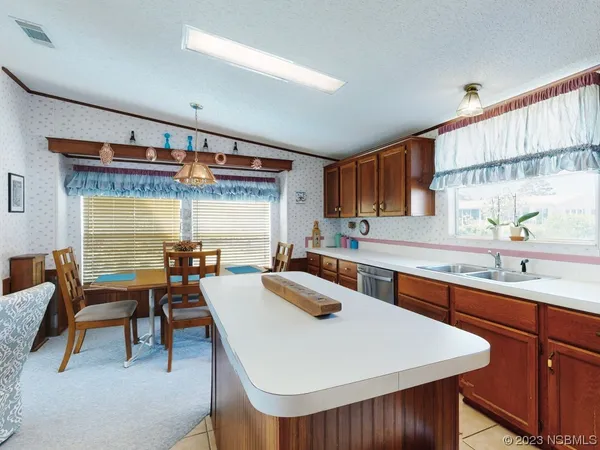 a kitchen with a sink a stove and chairs