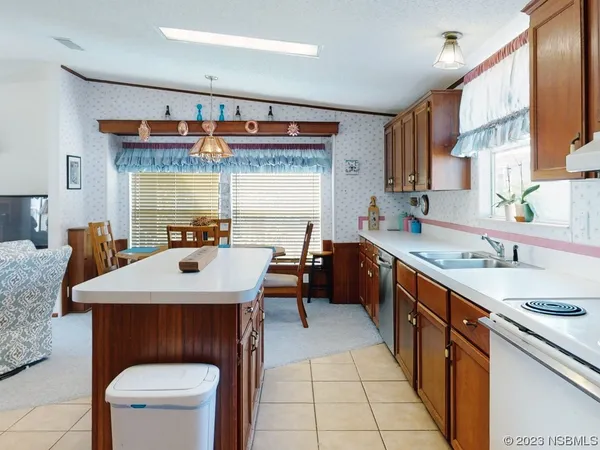 a kitchen with a sink refrigerator and cabinets