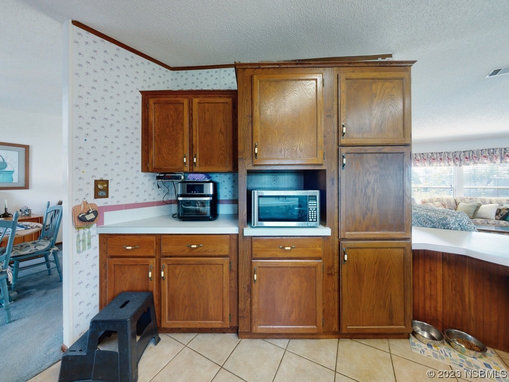 700 Starboard Avenue Edgewater, FL 32141 - Photo 14 of 47 a kitchen with granite countertop a sink and cabinets