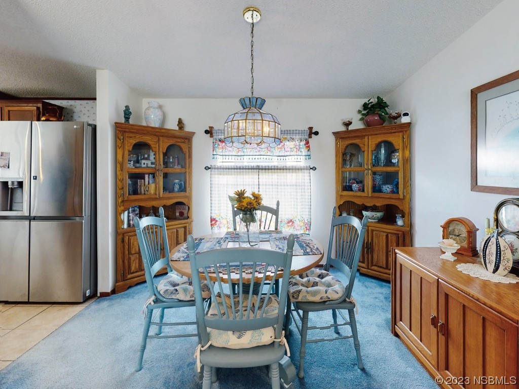 700 Starboard Avenue Edgewater, FL 32141 - Photo 15 of 47 a dining room with furniture a chandelier and wooden floor