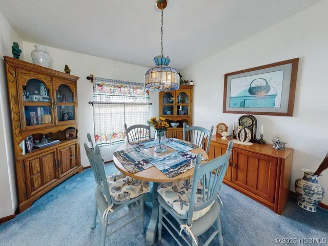 a dining room with furniture and window