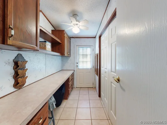a bedroom with two beds and a chandelier