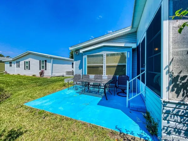 a view of house with backyard porch and sitting area