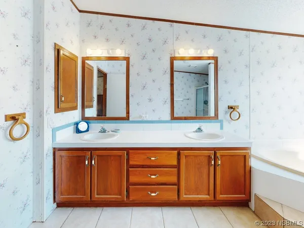 a spacious bathroom with a granite countertop sink and a mirror