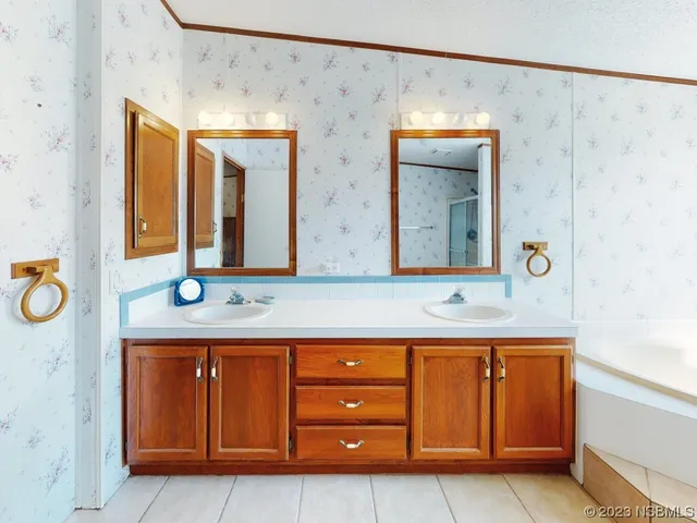a spacious bathroom with a granite countertop sink and a mirror