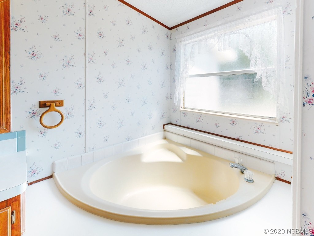 700 Starboard Avenue Edgewater, FL 32141 - Photo 27 of 47 a bathroom with a tub and a window