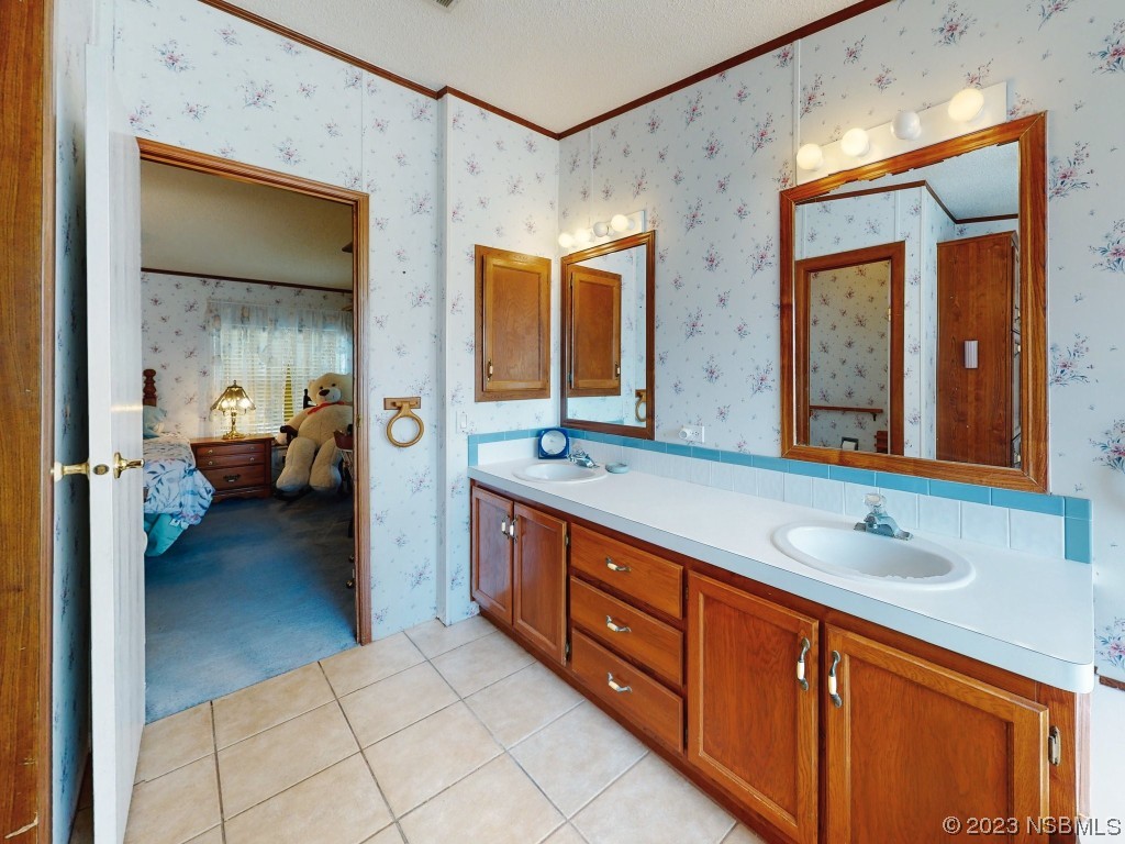 700 Starboard Avenue Edgewater, FL 32141 - Photo 28 of 47 a spacious bathroom with a granite countertop sink and a mirror