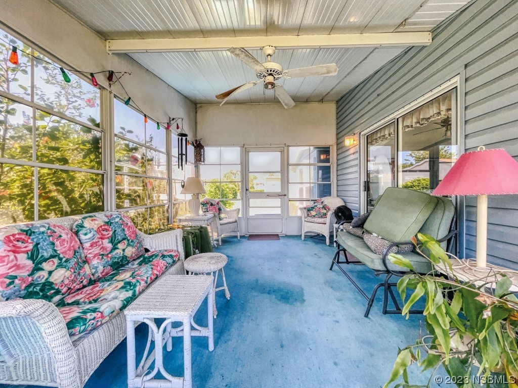 700 Starboard Avenue Edgewater, FL 32141 - Photo 30 of 47 a living room with furniture and a floor to ceiling window
