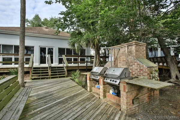 a view of swimming pool with seating space and wooden floor